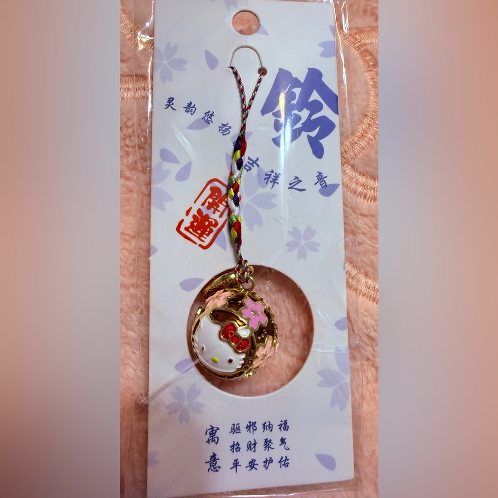 New Hello Kitty Gold Round Bell Charm features delightful sakura design 💖
